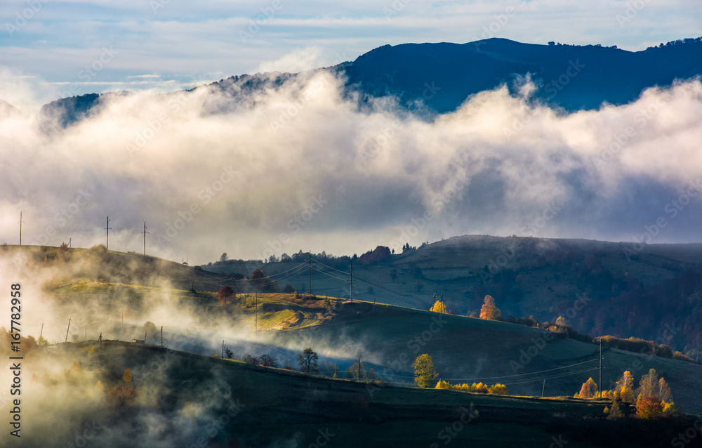 fog rising over the rural hills in morning light