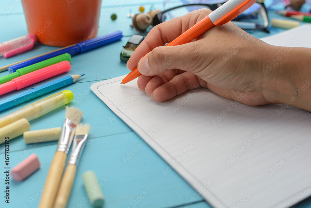 The girl writes in a notebook The girl writes in a notebook