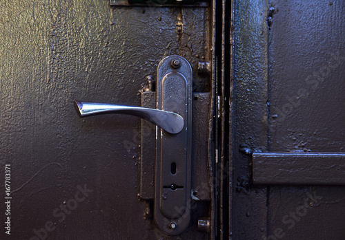 Iron door handle on iron gray doors