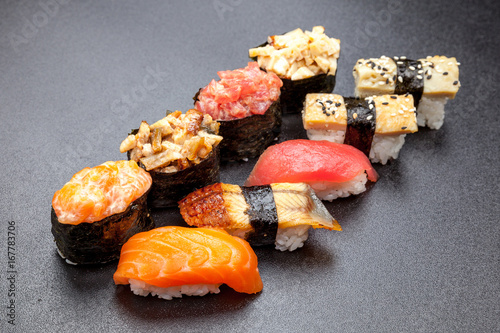 Many different sushi on a black table, Japanese food
