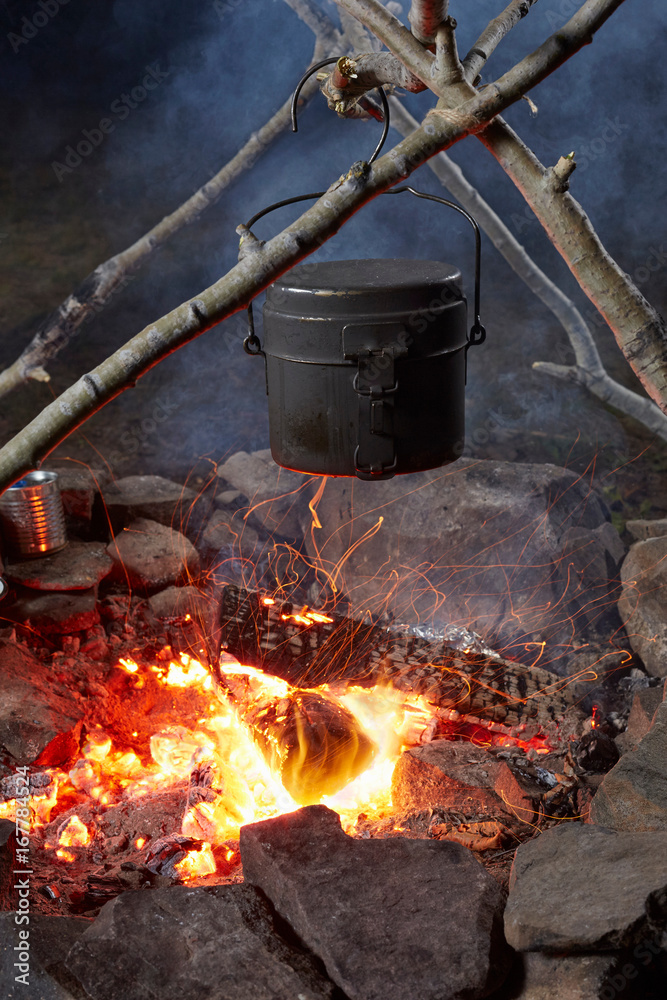 Pot of food cooking over camp fire, close-up, Colgate Lake Wild Forest, Catskill Park, New York State, USA Pot of food cooking over camp fire, close-up, Colgate Lake Wild Forest, Catskill Park, New York State, USA