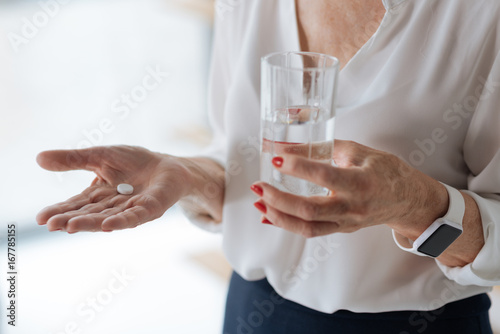 Painkiller pill with a glass of water