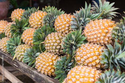 Many row of pineapple at market stall