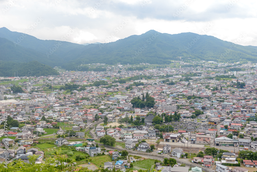 Ariel view of small town with mountain in background, Shimoyoshida in Yamanashi, Japan.