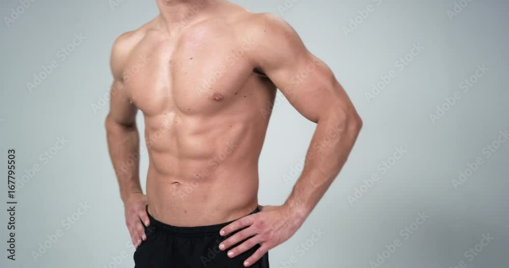 Close up man posing on a white background, shows his muscle and perfect body. 4k Close up man posing on a white background, shows his muscle and perfect body. 4k