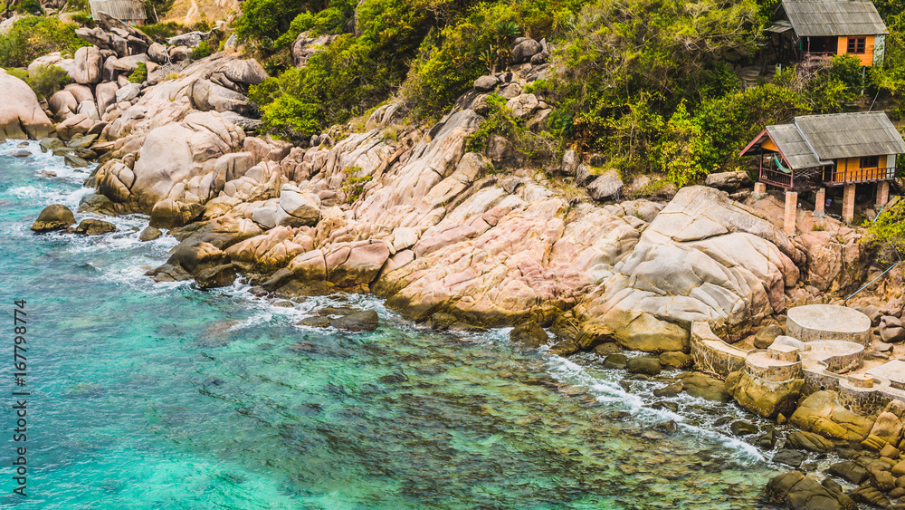 Rocky south costline of Koh Tao Islands with bungalows on granite rocks. Thailand