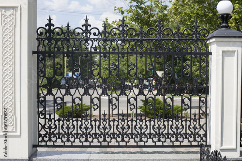 Wrought fence. Image of a decorative cast iron fence. metal fence close up. beautiful fence with artistic forging
