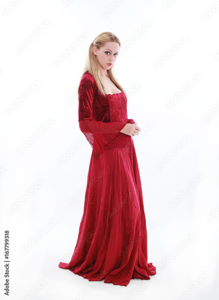 beautiful lady with long blonde hair wearing a red medieval fantasy gown. standing, isolated on white background. beautiful lady with long blonde hair wearing a red medieval fantasy gown. standing, isolated on white background.