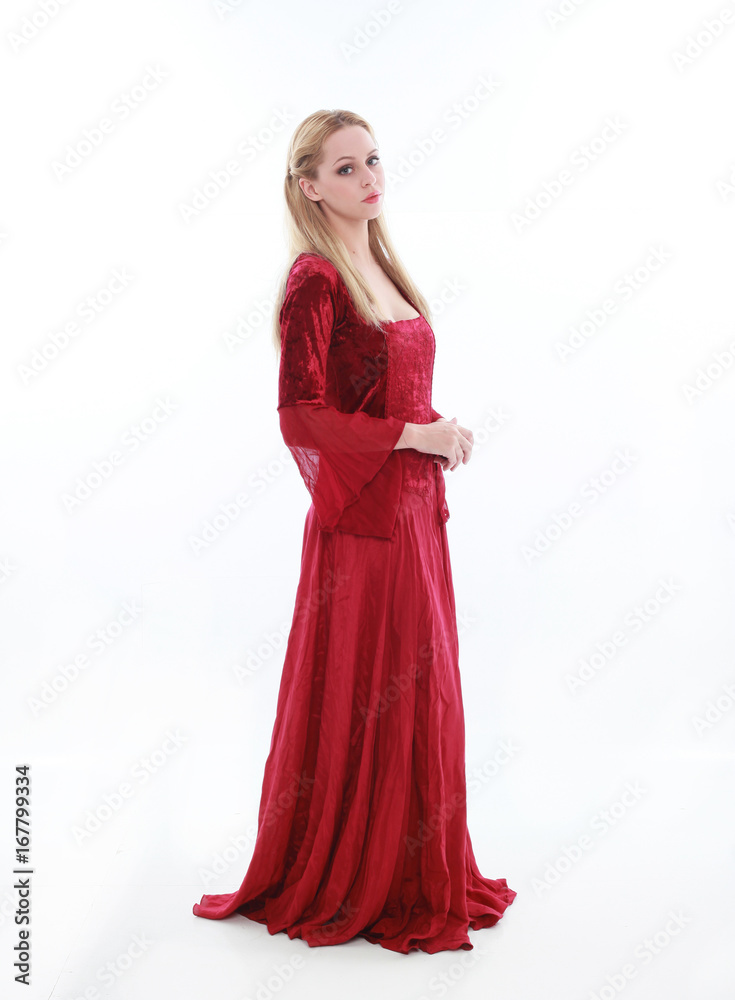 beautiful lady with long blonde hair wearing a red medieval fantasy gown. standing, isolated on white background.