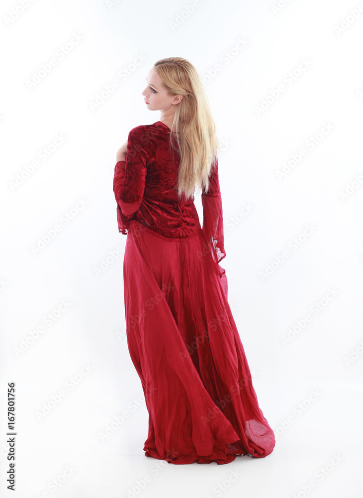 beautiful lady with long blonde hair wearing a red medieval fantasy gown. standing, isolated on white background. beautiful lady with long blonde hair wearing a red medieval fantasy gown. standing, isolated on white background.