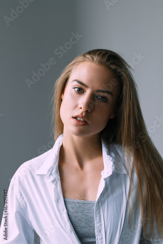 Girl with beautiful face and beautiful sports figure on a white background
