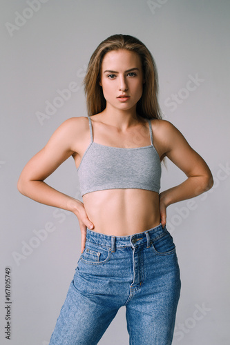 Girl with beautiful face and beautiful sports figure on a white background