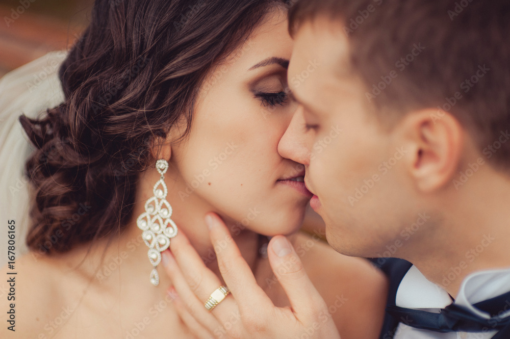 Beautiful and gentle kiss of the bride and groom Beautiful and gentle kiss of the bride and groom