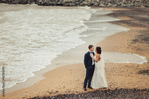 Beautiful wedding couple on a walk near water