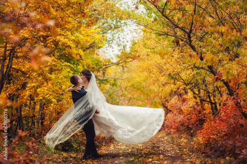 Wedding couple on a walk in the autumn park photo