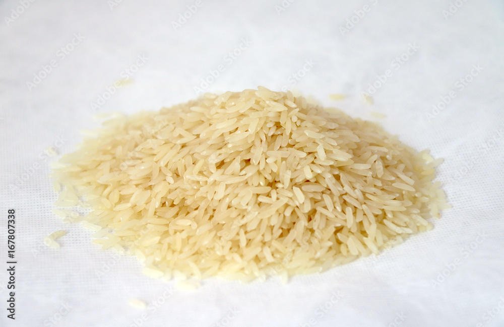 Pile of raw rice isolate on white background. rice is a swamp grass that is widely cultivated as a source of food, especially in Asia. Pile of raw rice isolate on white background. rice is a swamp grass that is widely cultivated as a source of food, especially in Asia.