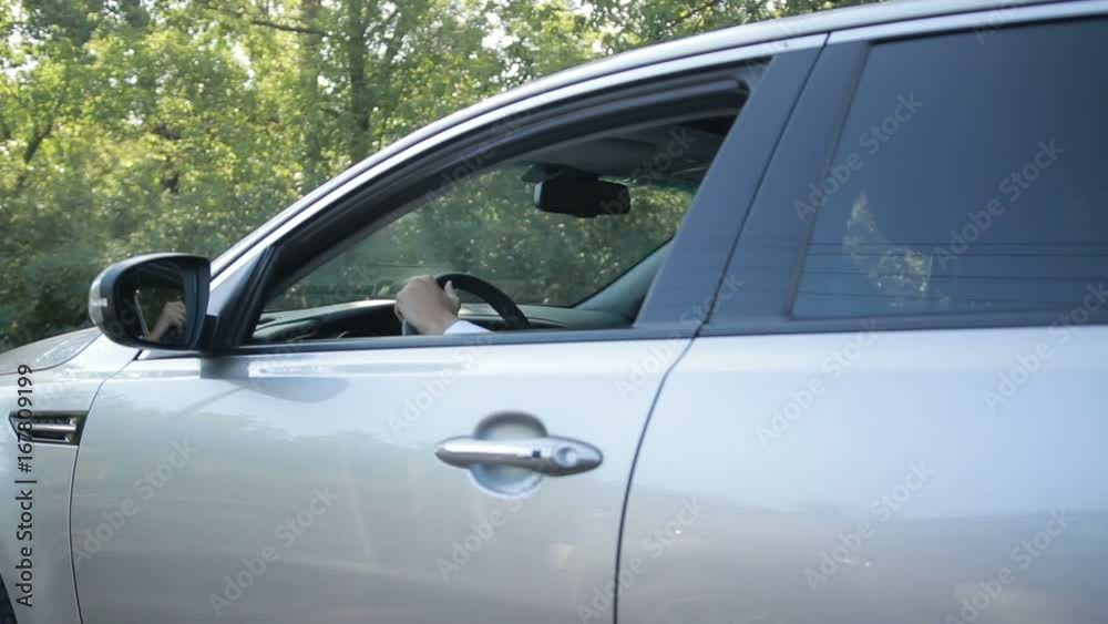 Handsome young man driving car on rural road Handsome young man driving car on rural road