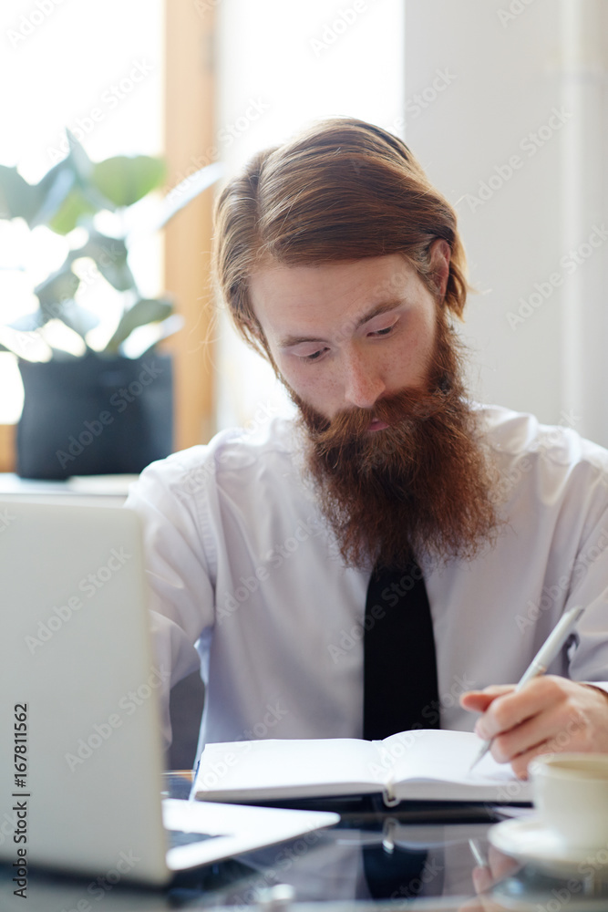 Busy entrepreneur making plan of work for the day Busy entrepreneur making plan of work for the day