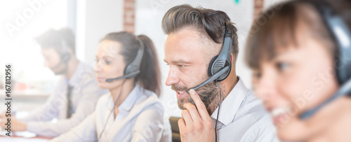 Call center worker accompanied by his team.