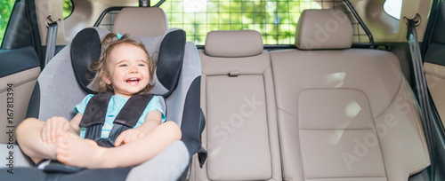 Infant baby girl buckled into her car seat.