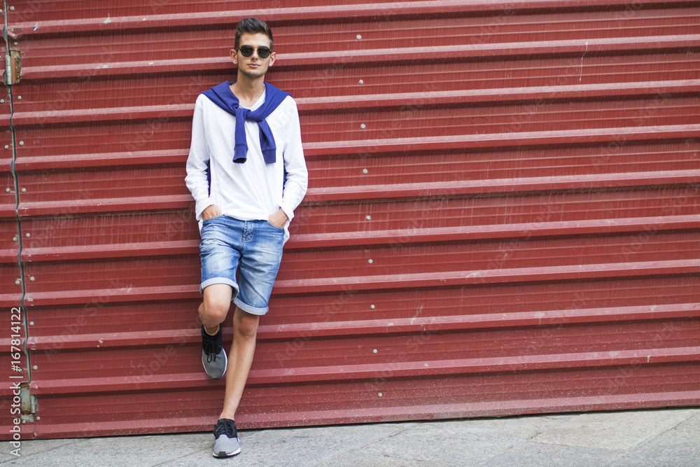 fashionable teenager on the wall of the street