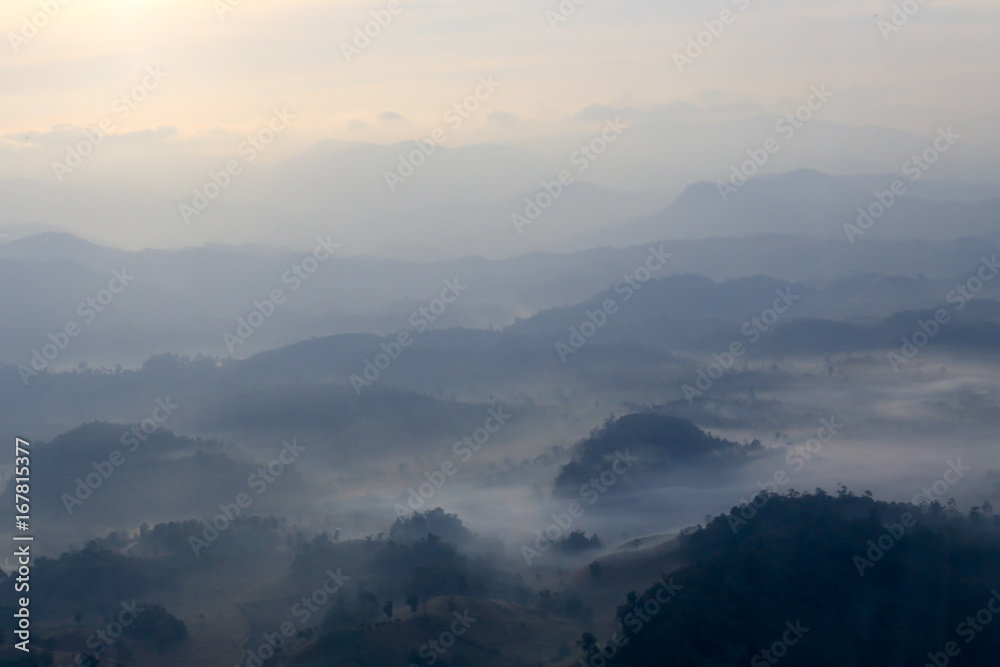 aerial view blurred mountain range cover by fog at dawn in Thailand