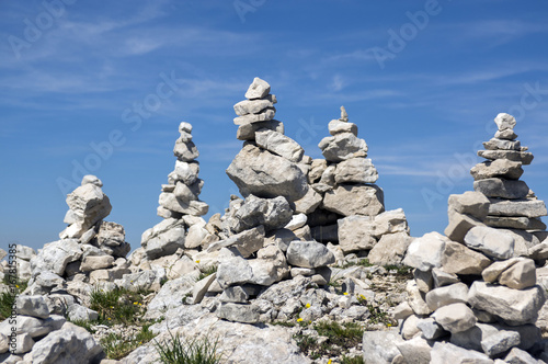 View point with white stone cairns on hiking trail Alta Via del Monte Baldo, ridge way in Garda Mountains © Iva
