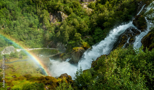Wild waterfall and a rainbow coming out of the water