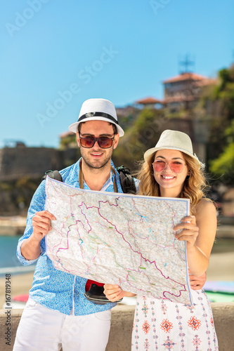 Couple tourist traveling and using map. Couple tourist exploring a city. photo