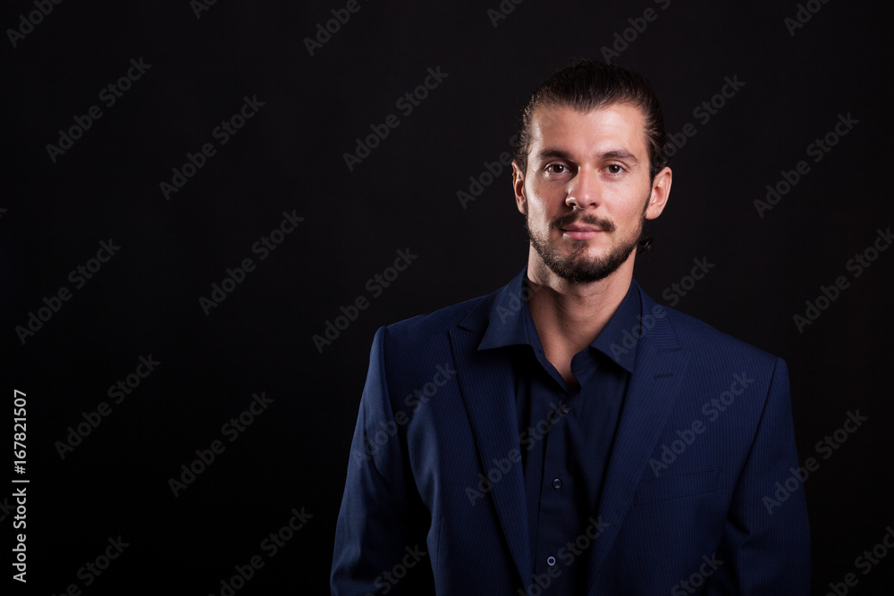 Portrait of businessman in suit on black background in studio photo Portrait of businessman in suit on black background in studio photo