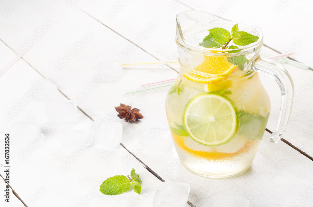Jug with Lime and Orange Fruit Water with ice