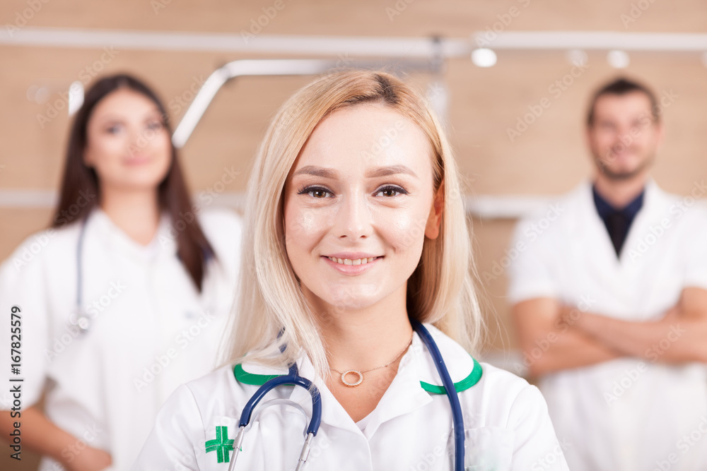 Portrait of confident doctor medical team with a blonde medic in front in hospital room Portrait of confident doctor medical team with a blonde medic in front in hospital room
