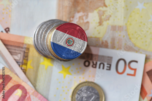 euro coin with national flag of paraguay on the euro money banknotes background.