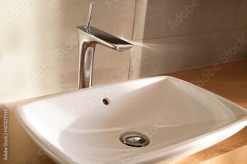 CLose up white comtemporary  luxury washbasin, tap