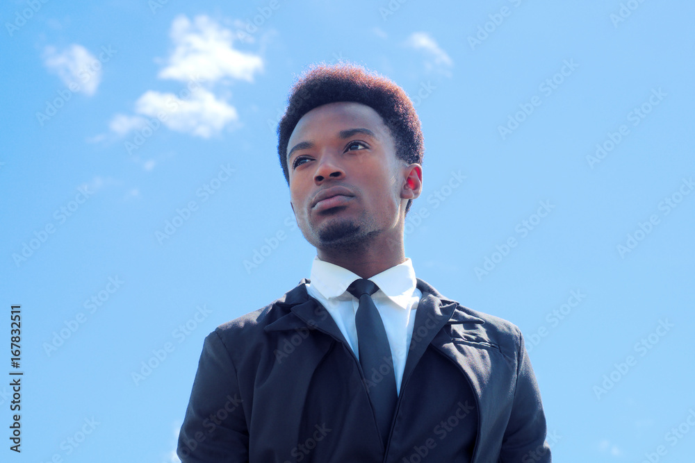 young businessman low angle view blue sky success looking foward young businessman low angle view blue sky success looking foward