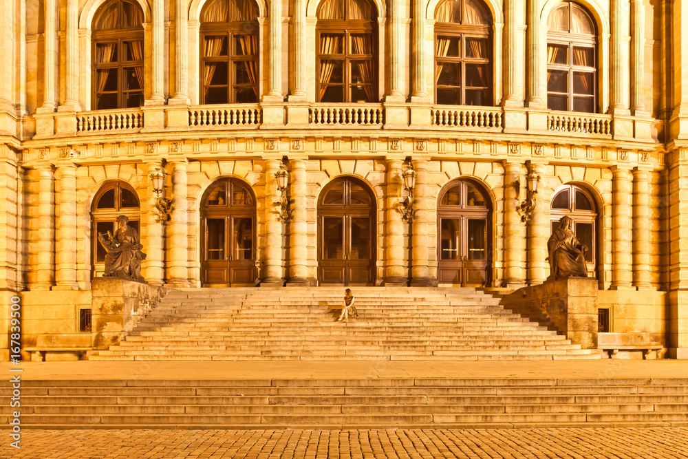 Woman sitting on the stairs of the Rudolfinum, Prague