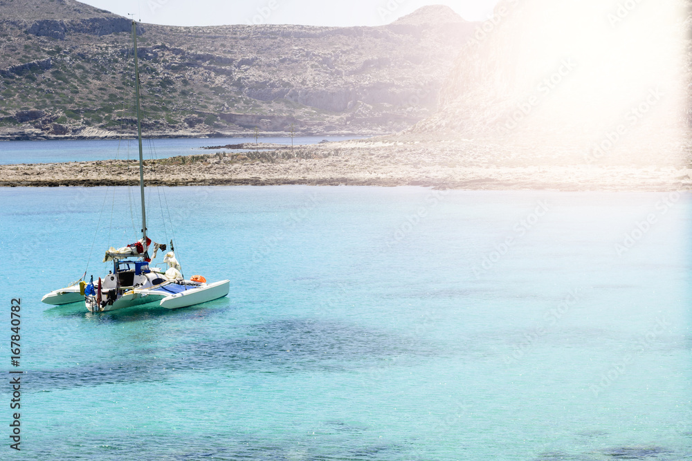 Fototapeta premium Beautiful seascape with white sailing yacht in the blue sea. Lowered the sails, calm. The concept of stagnation, travel, vacation