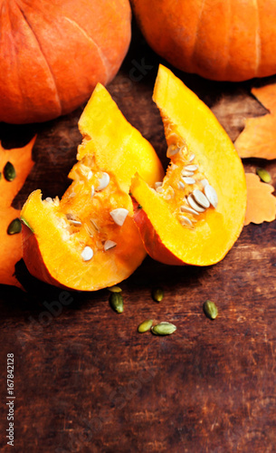 Autumn Pumpkin Thanksgiving Background concept  - orange pumpkins over wooden table with pieces.