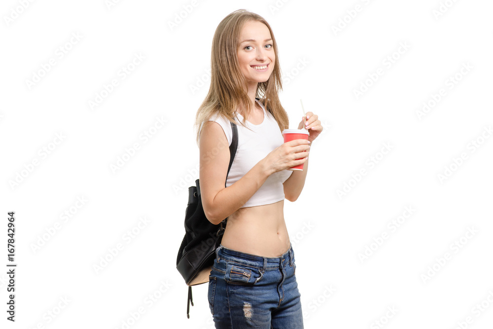 Beautiful young girl with a backpack and a cup of coffee Beautiful young girl with a backpack and a cup of coffee