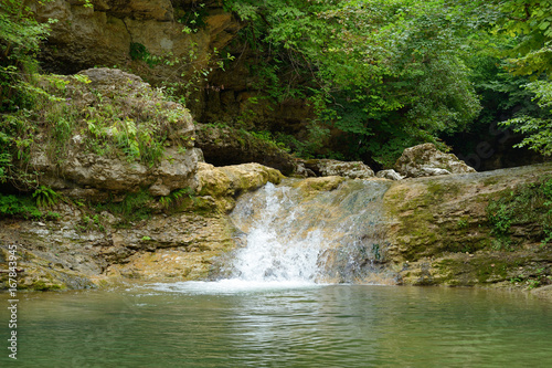 Small waterfall in mountain forest
