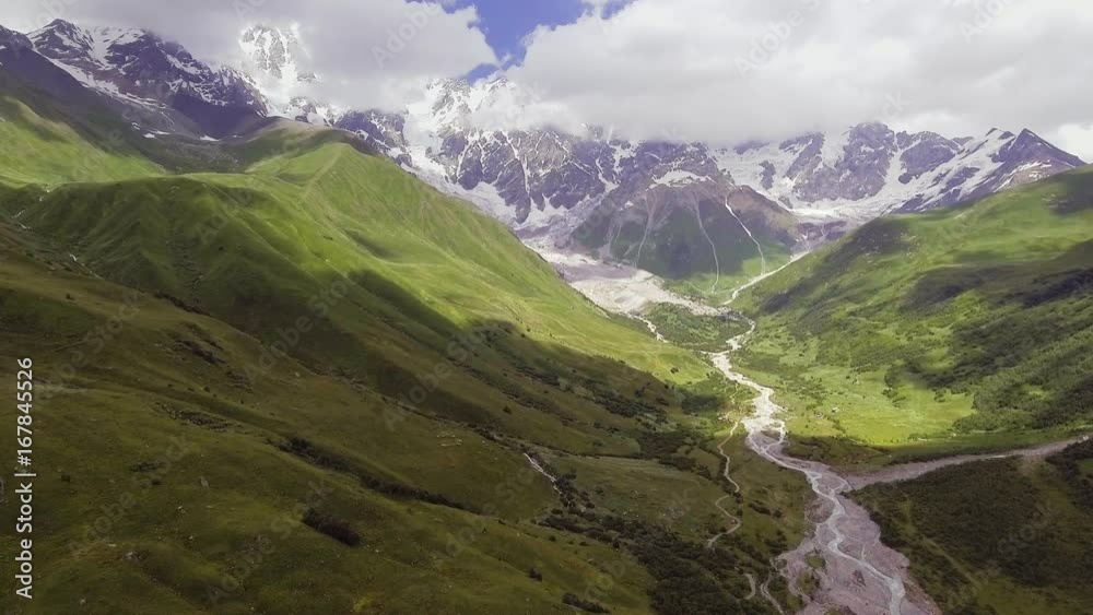 Aerial view of River in mountain valley at the foot of Mt. Shkhara. Georgia. Aerial view of River in mountain valley at the foot of Mt. Shkhara. Georgia.