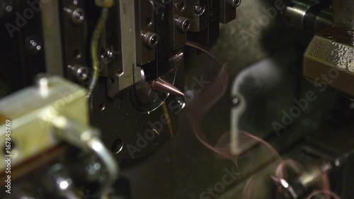 Machine sharpens bullets, close up