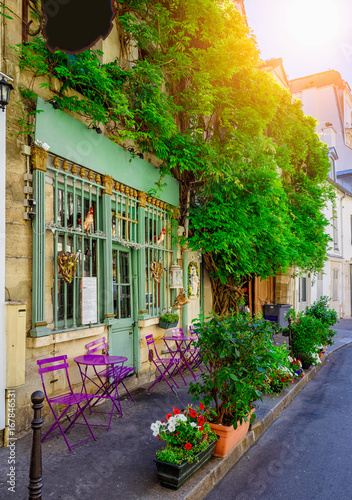 Fototapeta Naklejka Na Ścianę i Meble -  Cozy street with tables of cafe in Paris, France