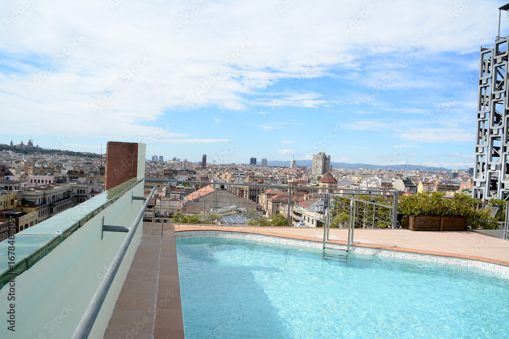 Panoramic view of barcelona from a roof terrace with pool