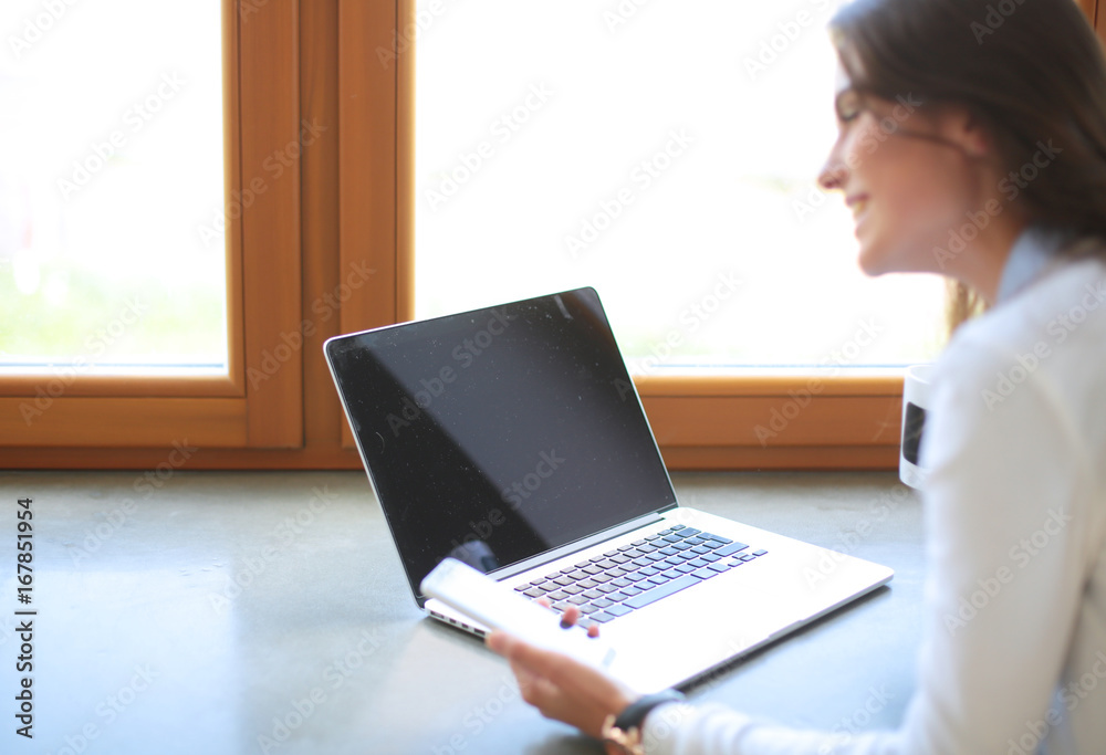 Young female standing near desk. Woman in the kitchen. Workplace Young female standing near desk. Woman in the kitchen. Workplace