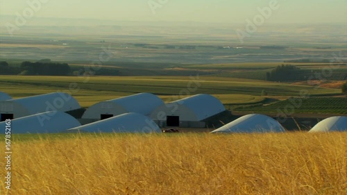 Pan left, warehouses in rural countryside
