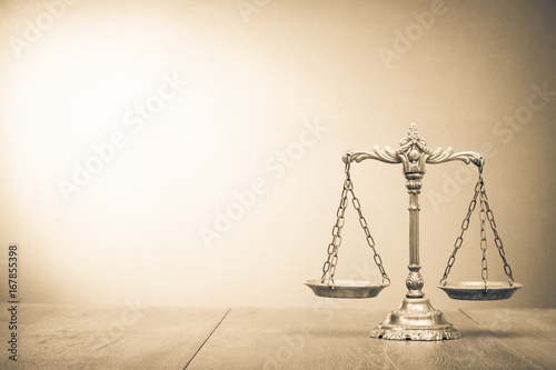 Retro law scales on table. Symbol of justice. Vintage style sepia photo photo