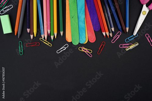 Education or Back To School concept. Stationery on a black background view from the top or flat lay.