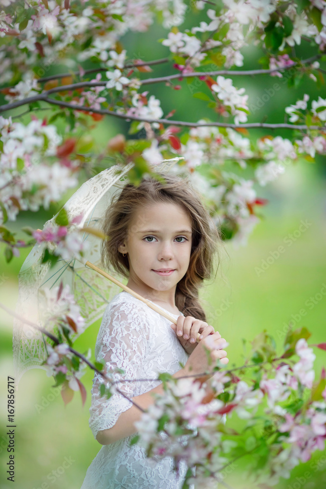 Spring portrait of young beautiful girl in a white dress with lace umbrella in apple blossoms Spring portrait of young beautiful girl in a white dress with lace umbrella in apple blossoms