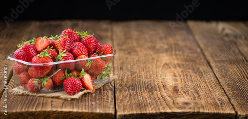 Strawberries on wooden background; selective focus